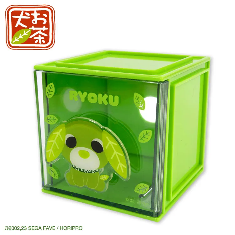 A green stacking storage cube with a character on the front